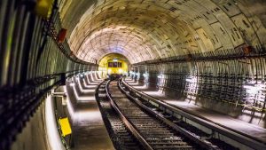 Dramatic view of a Berlin subway tunnel with train approaching, showcasing modern infrastructure.